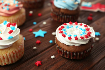 Delicious cupcakes on wooden background