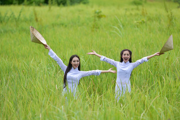 Women wear traditional Vietnamese .