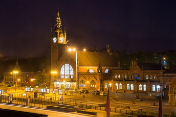Night view of the building's main train station in Gdansk in the old eclectic style.
