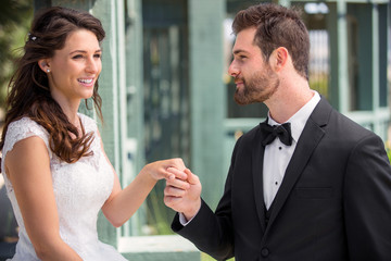 Beautiful newlywed couple outdoor on wedding day together in joy and happiness