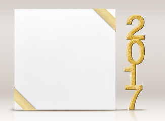 2017 New year glitter number and white card with gold ribbon in