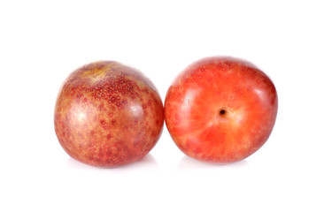 whole ripe Pluot on white background