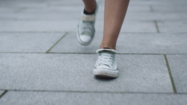 Shot of Women Legs in Sneakers Walking on Tile Road. Urban Environment. Shot on RED Cinema Camera in 4K (UHD).