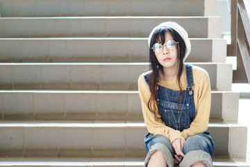 Asian girl wearing jean overalls