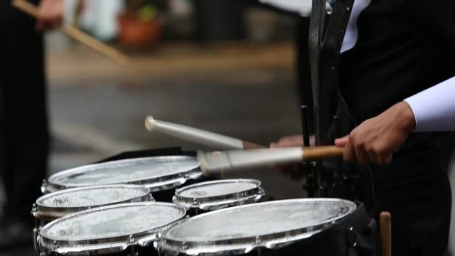 Drummers in a Marching Band. Drummers playing snare drums in parade