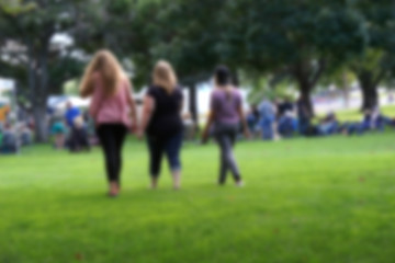 Obraz na płótnie Canvas blur background of people walking through park