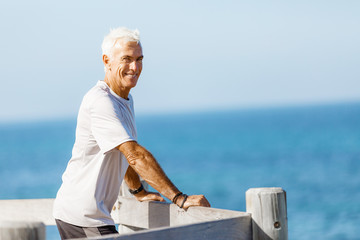 Man standing on beach in sports wear