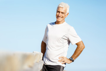 Man standing on beach in sports wear