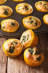 Delicious Muffins with spinach and feta cheese close-up. vertical
