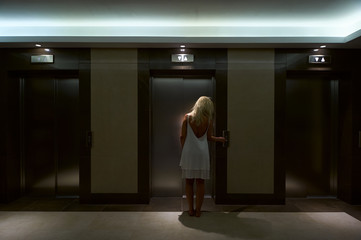 Women pressed the Button of Elevator
