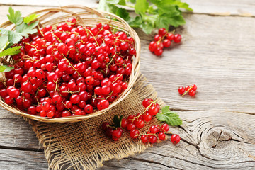 Red currant on a grey wooden table
