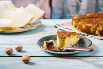 Melon cake on turquoise shabby wooden background with slices of melon and nutmeg.  Autumn baking. Selective focus 