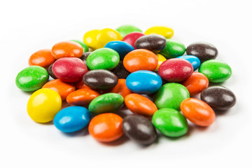 Multicolored chocolate pieces with a candy shell isolated on white background