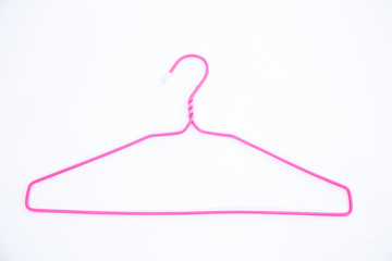 Pink wire hangers on white background