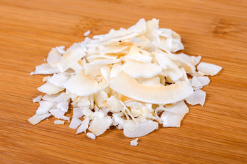 Dried coconut isolated on wood background