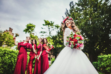 Bride with bridesmaids in a park