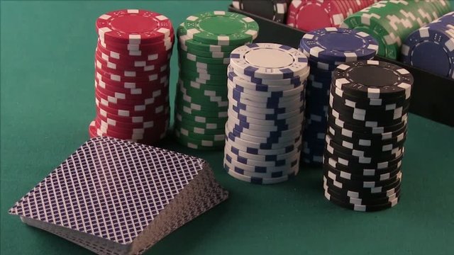 Poker Chips and Playing Cards on the Poker Table