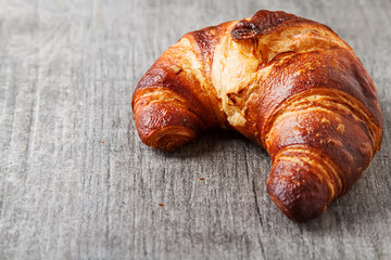 French food for breakfast. Fresh baked croissants. Light wood ba