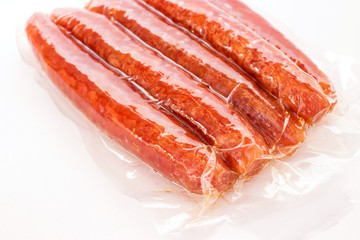 Chinese sausage in vacuum package isolated on white background