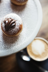 Close up of delicious chocolate donuts on a marble platter