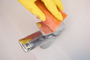 Wash dirty tap with a sponge.