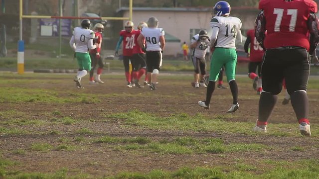 Quarterback running to end-zone and gets tackled, football game in small town