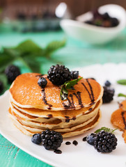 Delicious pancakes with blackberries and chocolate.