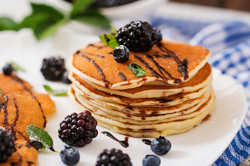 Delicious pancakes with blackberries and chocolate.