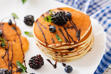 Delicious pancakes with blackberries and chocolate.