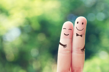 Happy couple finger Man and woman hug and smiling faces with bokeh nature background, outdoor.