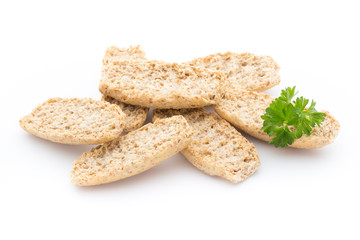 Dry flat bread crisps with herbs on a white background.