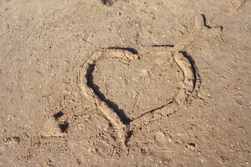 Heart with an arrow out of the sand   