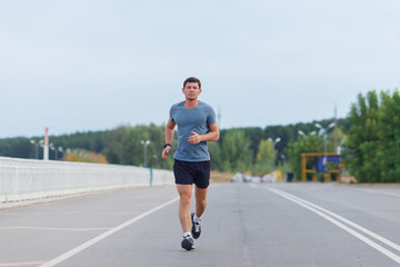 Jogging lifestyle - young attractive man running outdoors