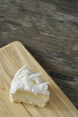 Coconut cake slice on wood plate