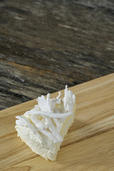 Coconut cake slice on wood plate