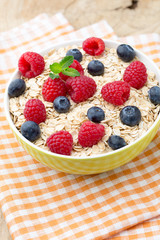 Oatmeal porridge with berries. Raspberries and blueberries.