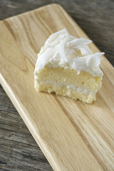 Coconut cake slice on wood plate