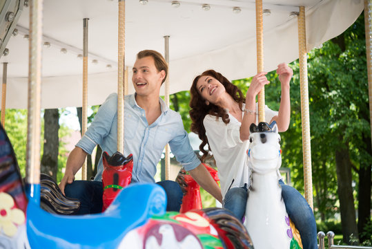 Couple having fun on a carousel
