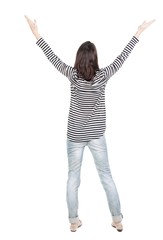 Back view of  joyful woman celebrating victory hands up. Rear view people collection. backside view of person. Isolated over white background. slender brunette in a jeans shows the symbol of success