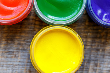 cans gouache on a wooden background