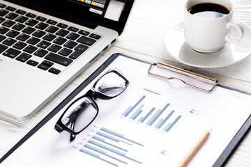 workplace economist at office table with laptop