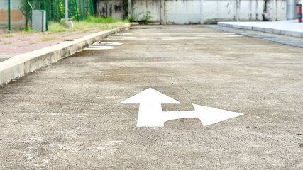 White forward and right directional arrow on asphalt, Turn right symbol