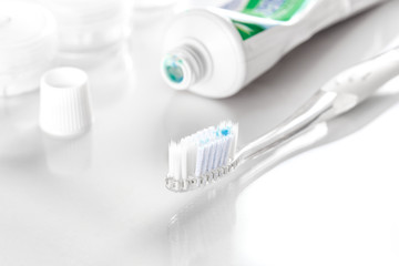 toothpaste and toothbrush on white background