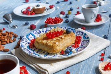 Pastry pie, tea, coffee and berries at blue rustic wood