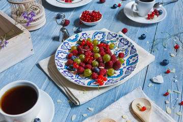 Breakfast with baked pea and berries at blue rustic wood