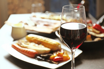 Glass of wine and grilled vegetables on served table
