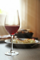 Glass of wine and grilled vegetables on served table