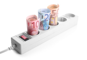 Euro banknotes in power socket on white background