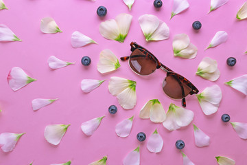 Vintage background with sunglasses and flower petals