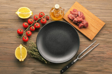 Empty plate with ingredients for dinner on table